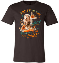 Load image into Gallery viewer, Brown t-shirt with a lion, cross, and pumpkin design with text 'Trust in the Lord with all your heart' on a white background.