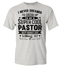 Load image into Gallery viewer, A light heather gray short-sleeve t-shirt with a black graphic text print on the front that reads, 'I NEVER DREAMED I'D GROW UP TO BE A SUPER COOL PASTOR BUT HERE I AM killing it!'.