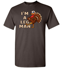 Load image into Gallery viewer, Brown t-shirt with a turkey graphic and text &#39;I&#39;m a Leg Man&#39; on a white background