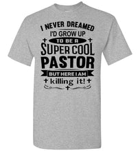 Load image into Gallery viewer, A heather gray short-sleeve t-shirt with a black graphic text print on the front that reads, 'I NEVER DREAMED I'D GROW UP TO BE A SUPER COOL PASTOR BUT HERE I AM killing it!'.