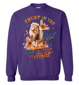 Purple sweatshirt with a lion, cross, and floral design on a white background