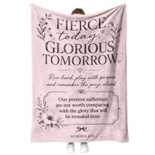 Load image into Gallery viewer, A person holds up a large pink fleece blanket with black printed inspirational text and floral illustrations. The blanket reads, 'Fierce today, glorious tomorrow' and includes a Bible verse from Romans 8:25-28.