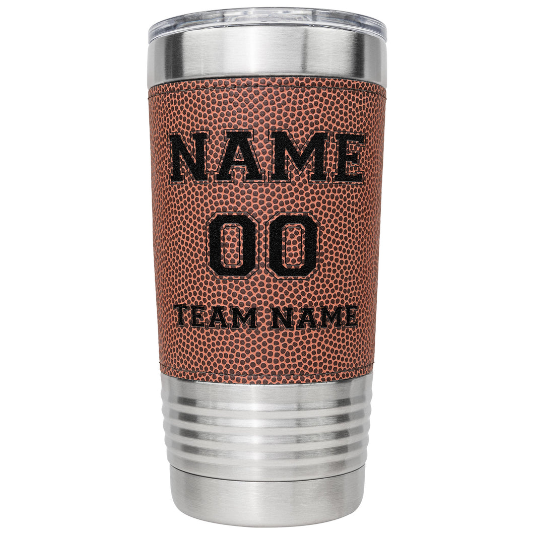 Stainless steel tumbler with football pattern and engraved text on a white background