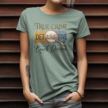 Load image into Gallery viewer, Person wearing a green t-shirt with 'True Crime Detective Couch Division' design.