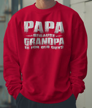 Load image into Gallery viewer, Red sweatshirt with text &#39;PAPA BECAUSE GRANDPA IS FOR OLD GUYS&#39; worn by a person.
