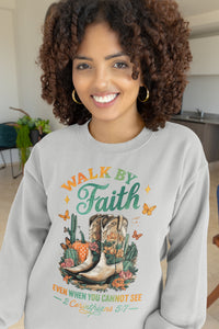 Woman wearing a gray sweatshirt with 'Walk by Faith' design in a kitchen.