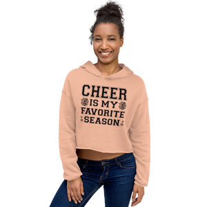 Woman wearing a peach hoodie with 'CHEER IS MY FAVORITE SEASON' text on a white background