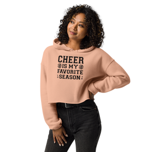 Woman wearing a peach hoodie with 'Cheer is my favorite season' text on a white background